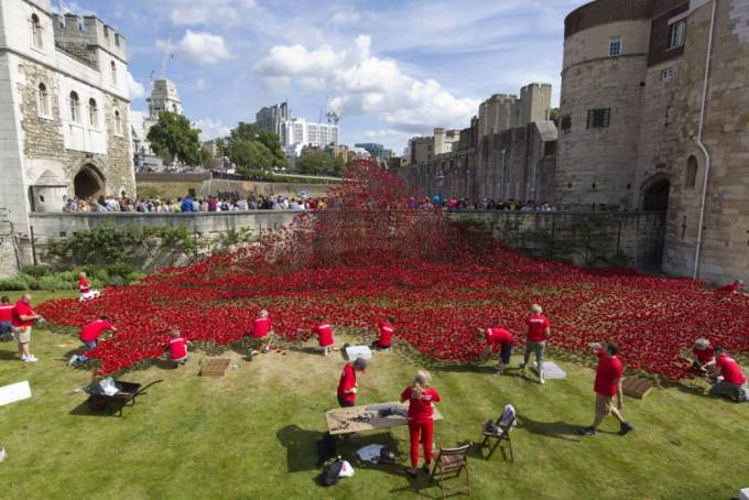 Workers carefully placing the poppies in the Tower Moat