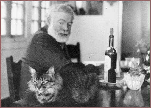 Hemingway with cat and bottle