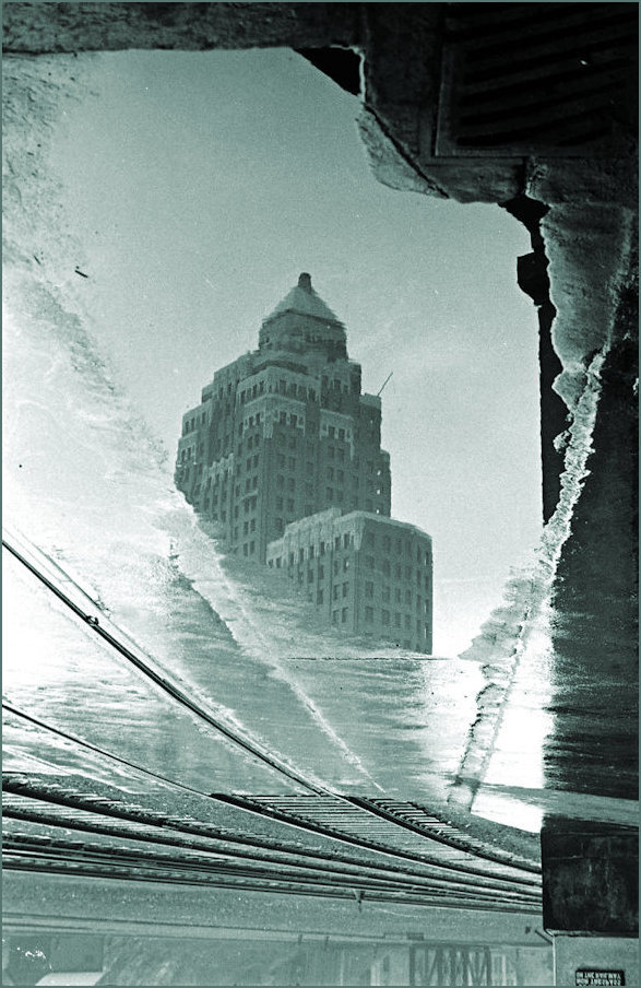 Marine Building reflected in a puddle