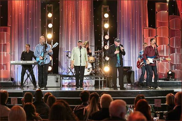 Beach Boys in a moments silence on stage