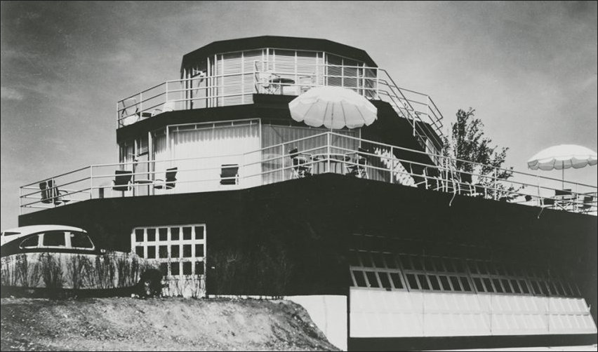 The hour of Tomorrow featuring a garage and small aircraft hangar attached to the house