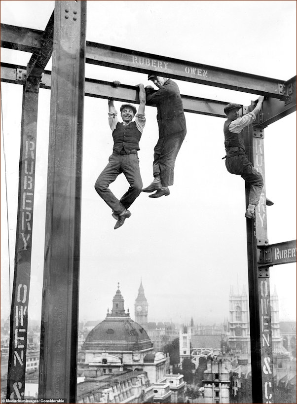 Men hanging fro struts at 55Broadway