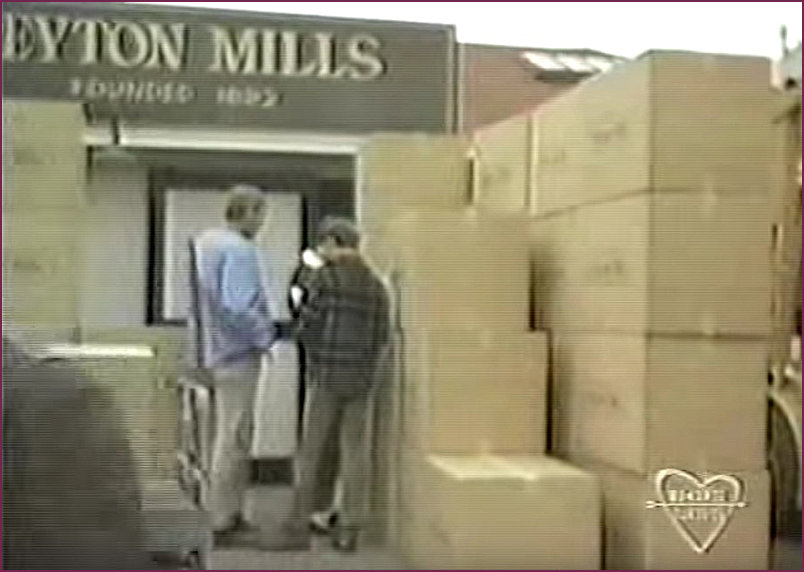 Characters pondering the new shipment of boxes arriving at the wharf mill